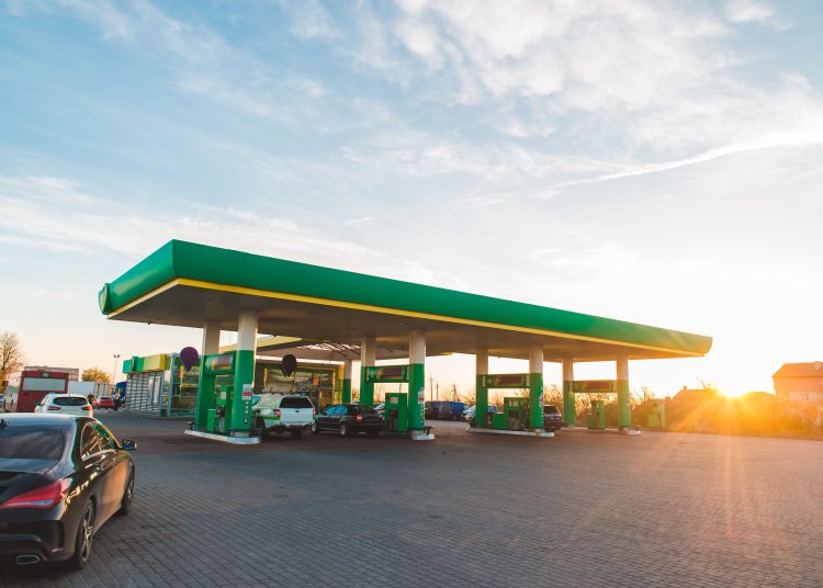 wide view of gas station on sunset copy space