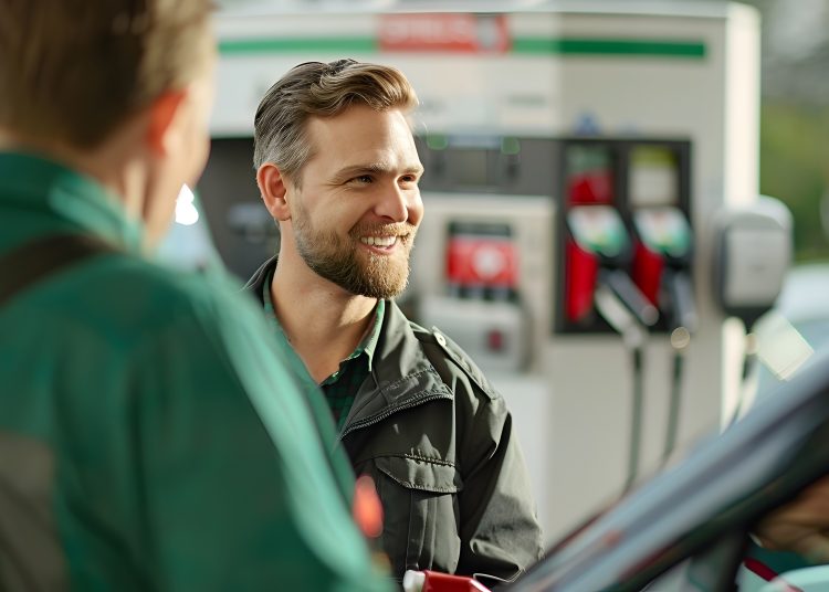 Friendly Attendant Assisting Customer with Refueling Their Vehicle at a Well-Maintained and Branded Gas Station Facility