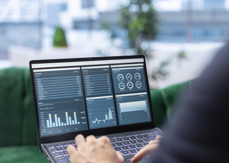 Determined CEO works in office analyzing infographics and setting business goals to drive corporate growth, global investment strategy in a competitive environment. Leadership skills.