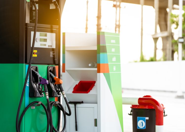 Petrol pump filling fuel nozzle in gas station. Fuel dispenser machine. Refuel fill up with petrol gasoline. Petrol industry and service. Petrol price and oil crisis concept. Petroleum oil industry.