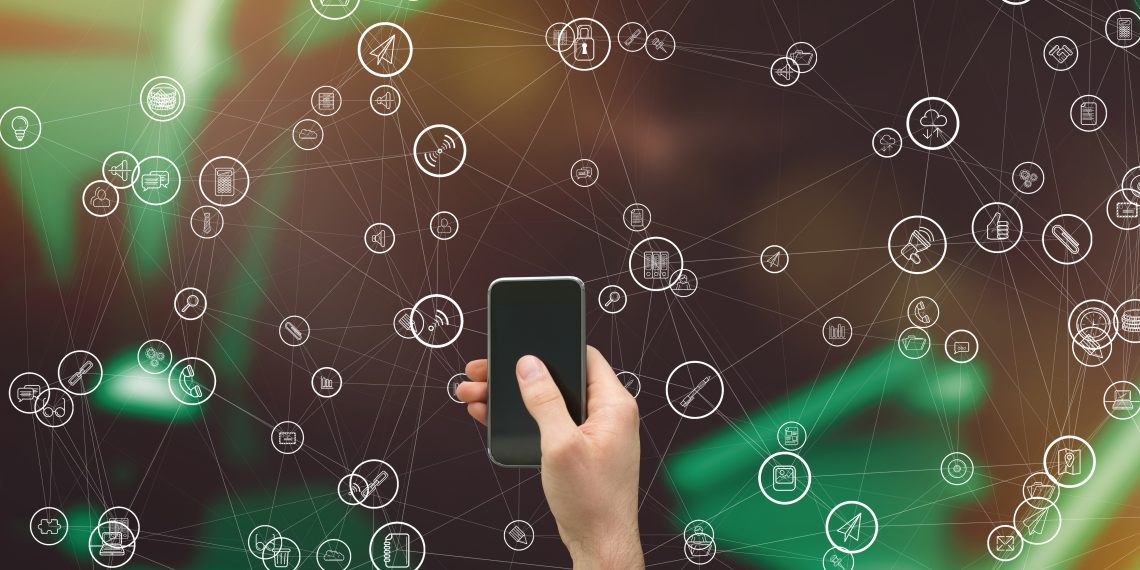 digital composite of hand holding smartphone with vignettes