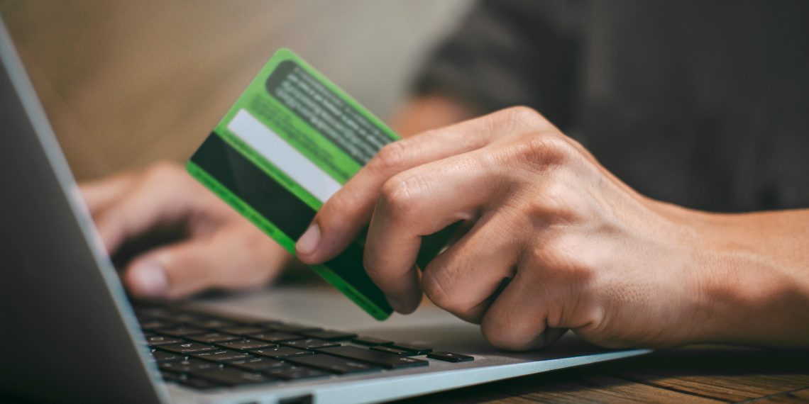 Businessman holding credit card and typing on laptop for online shopping and payment makes a purchase on the Internet, Online payment, Business financial and technology.