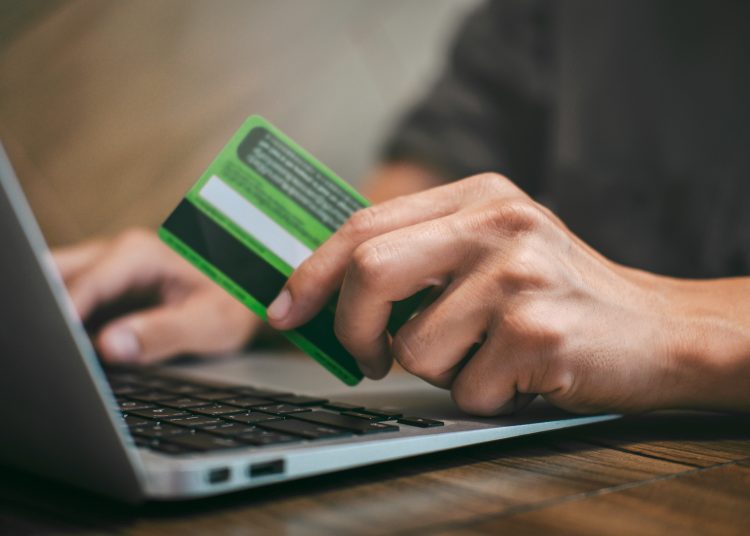 Businessman holding credit card and typing on laptop for online shopping and payment makes a purchase on the Internet, Online payment, Business financial and technology.